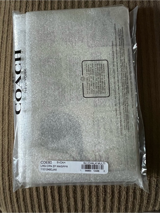 Coach Handbags - Coach Large Corner Zip Wristlet
With Newspaper Print NWT (the print will vary)